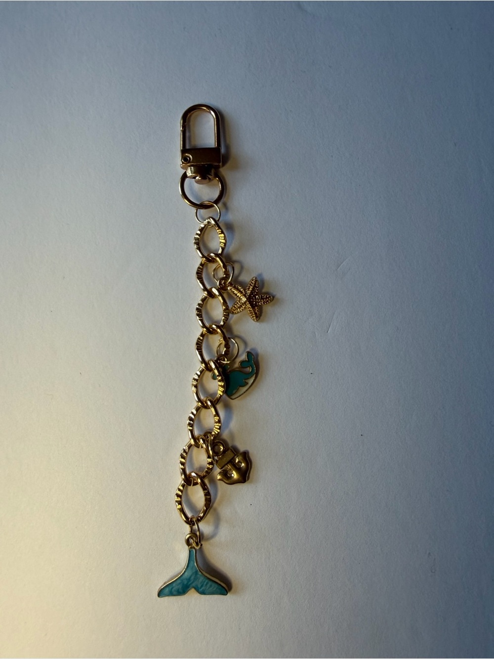 Gold-Tone Sea Bag Charm with Teal Accents